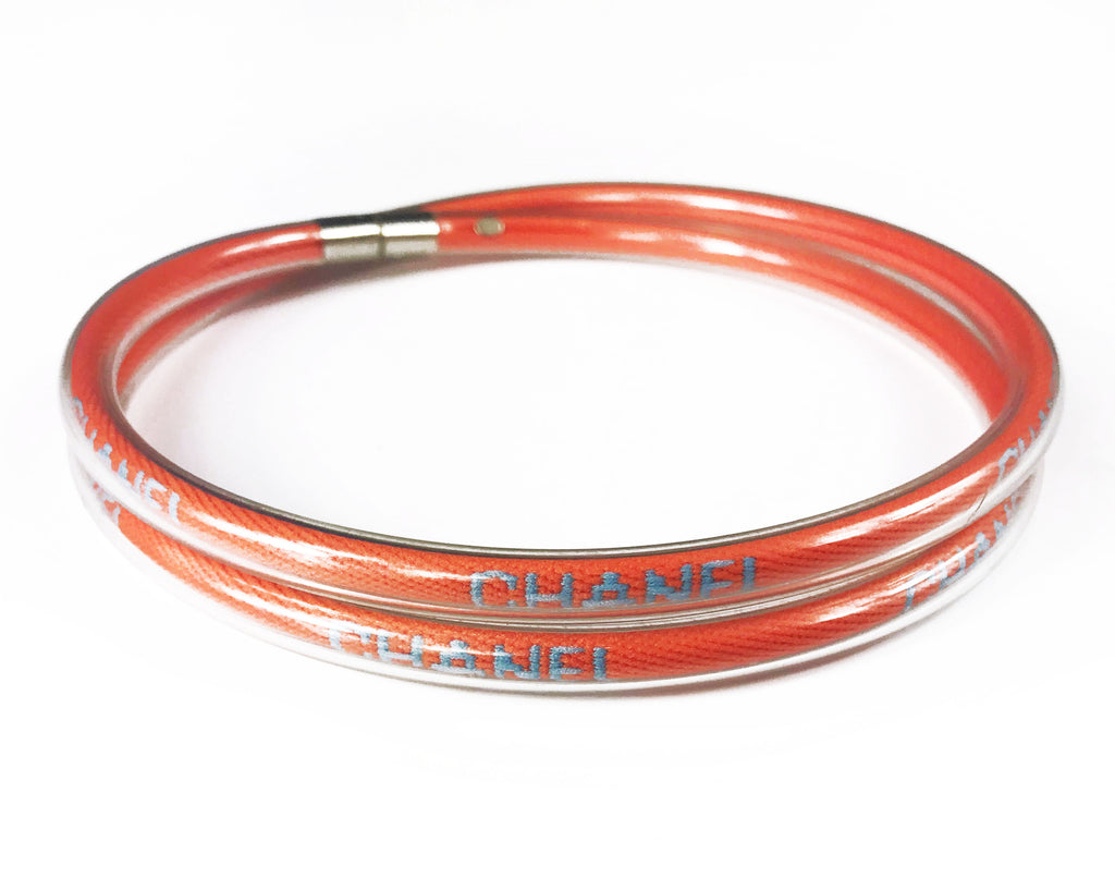 Fruit Vintage Chanel orange wrap around rubber tubing choker with CHANEL text logo all around.