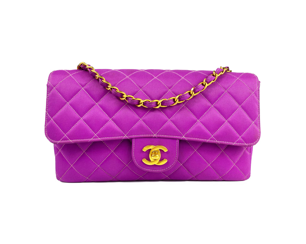 Fruit Vintage classic Chanel quilted nylon flap bag in extremely rare purple nylon, dating to 1995. Features the classic Chanel flap structure with contrast pale purple stitching and matte gold hardware.