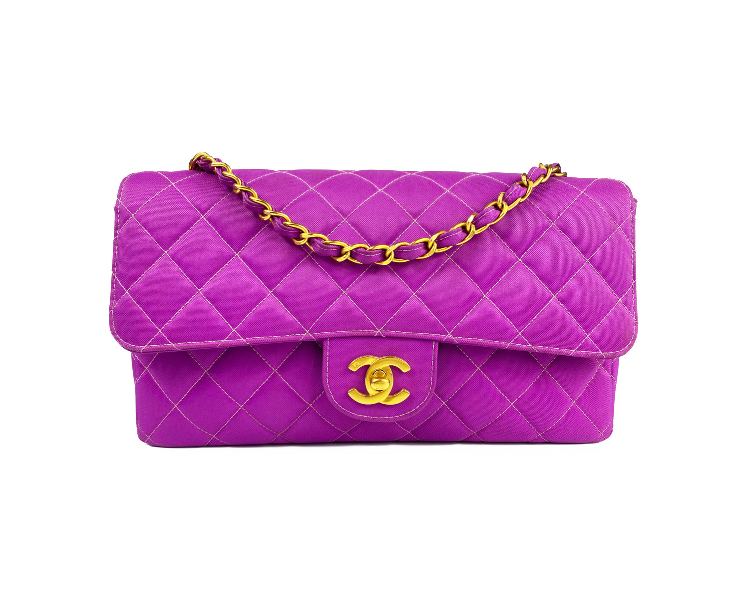 Fruit Vintage classic Chanel quilted nylon flap bag in extremely rare purple nylon, dating to 1995. Features the classic Chanel flap structure with contrast pale purple stitching and matte gold hardware.