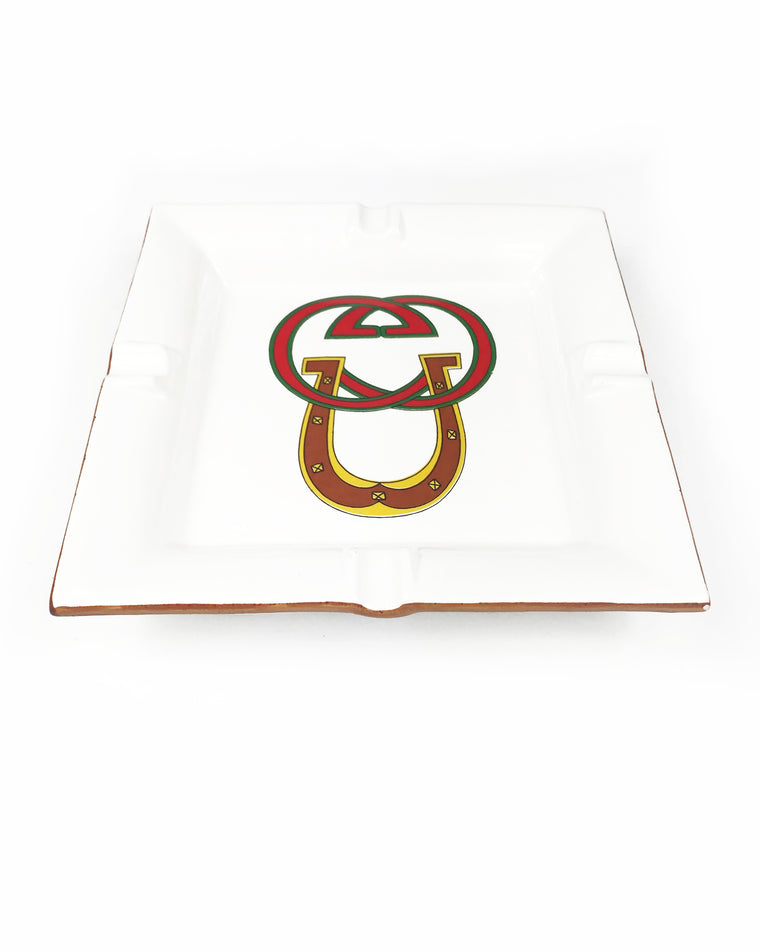 FRUIT Vintage Gucci hand painted 1980's porcelain logo ashtray or change tray. Features a classic ashtray shape, brown trim and Gucci suede logo fabric and mark at base. This is a very special piece!