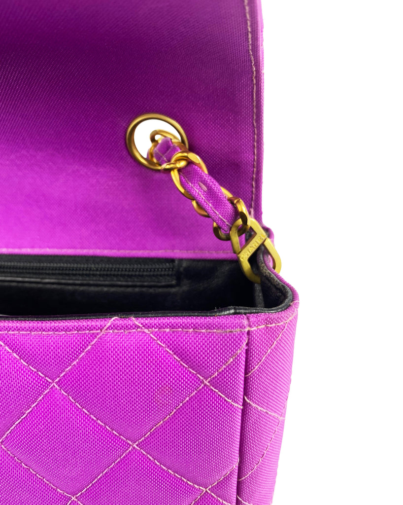 Fruit Vintage classic Chanel quilted nylon flap bag in extremely rare purple nylon, dating to 1995. Features the classic Chanel flap structure with contrast pale purple stitching and matte gold hardware.