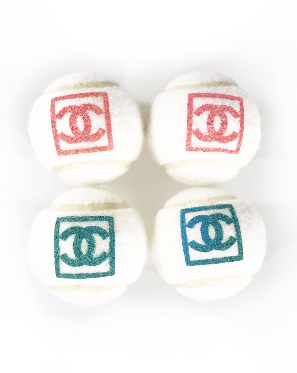 Fruit Vintage Chanel tennis ball set - a rare and important Chanel collectors accessory. It features a 4 Chanel tennis balls (2 pink and 2 blue) in a navy zipper accessory pouch with logo embroidery.