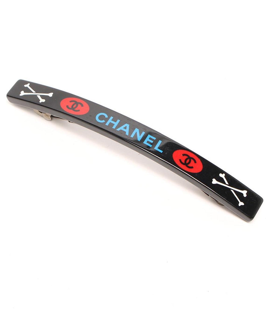 Fruit Vintage Chanel 2003 text logo barrette in black with cross bones. Features large Chanel text logos and two CC monograms either side.