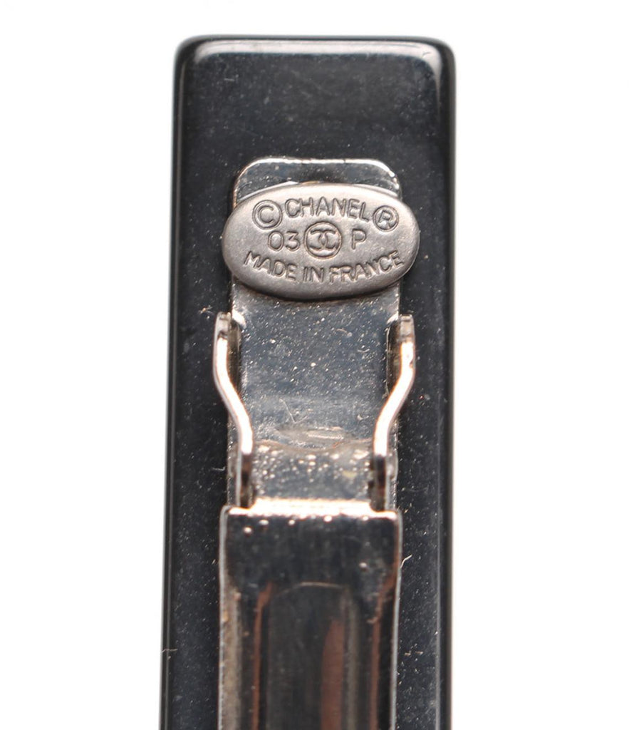Fruit Vintage Chanel 2003 text logo barrette in black with cross bones. Features large Chanel text logos and two CC monograms either side.