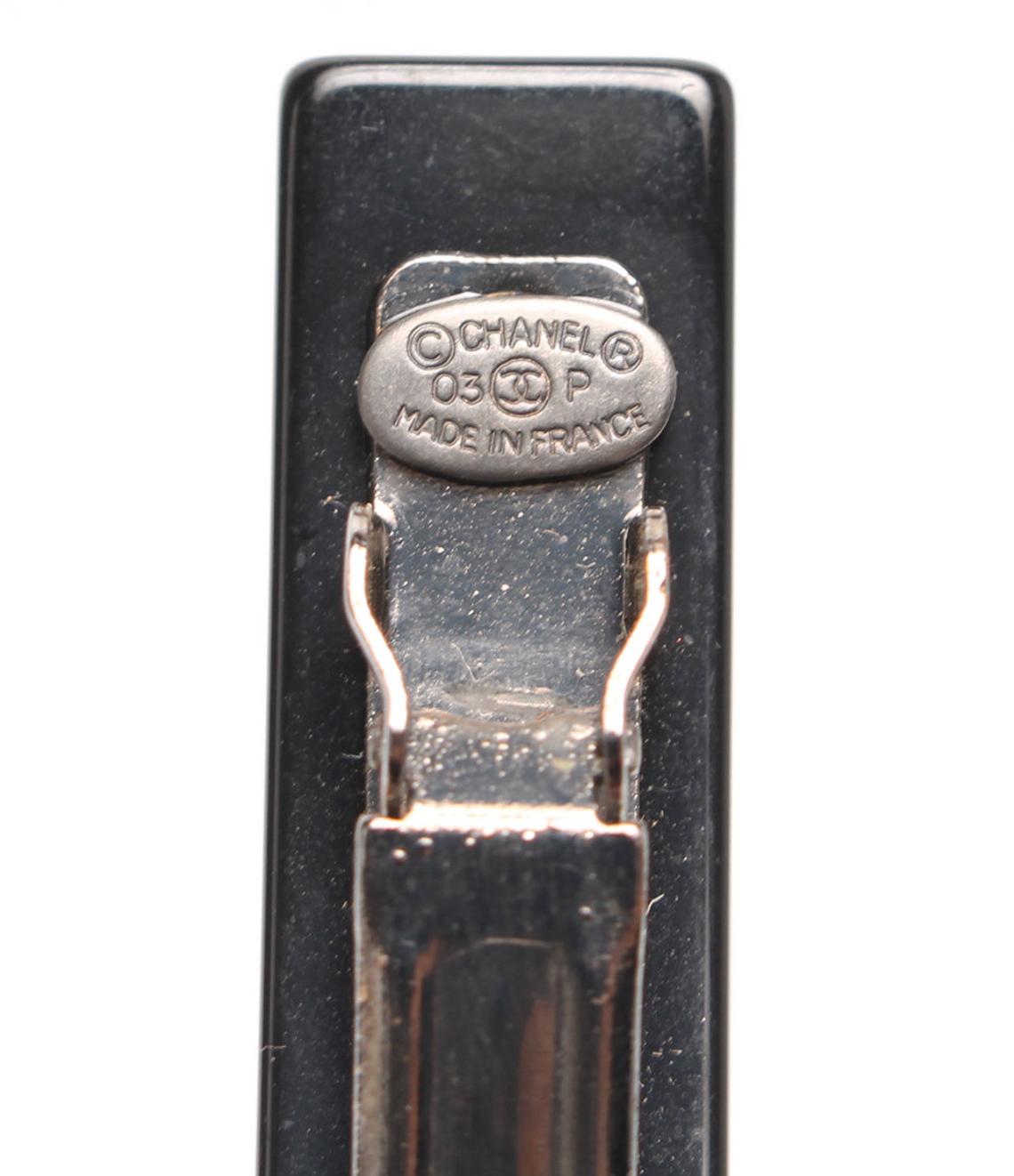 Fruit Vintage Chanel 2003 text logo barrette in black with cross bones. Features large Chanel text logos and two CC monograms either side.