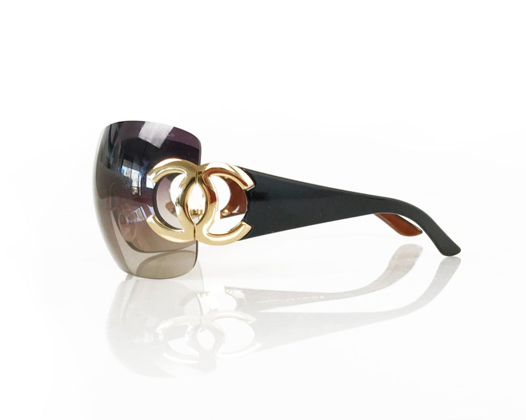 Fruit Vintage Chanel large Y2K logo sunglasses. They feature big Chanel CC logo monograms to each side and a classic early 2000s shield shape.