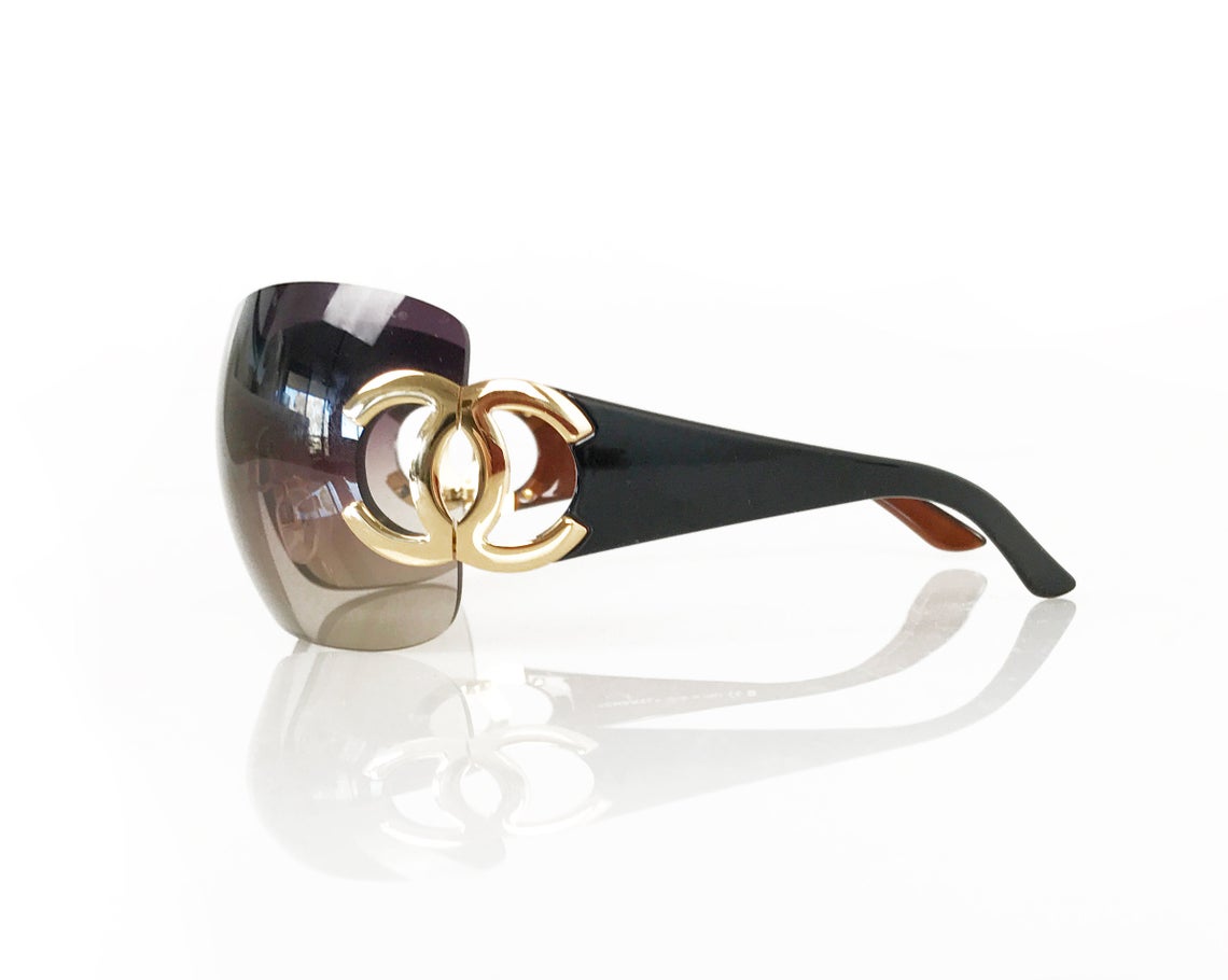 Fruit Vintage Chanel large Y2K logo sunglasses. They feature big Chanel CC logo monograms to each side and a classic early 2000s shield shape.