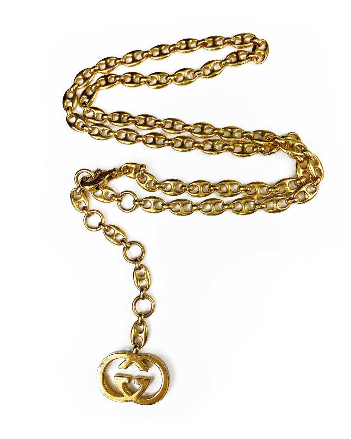 Fruit Vintage Gucci 1980s logo chain belt in classic gold. Features a lobster clip closure and significant logo drop Gucci GG charm. Looks incredible when worn as a necklace.