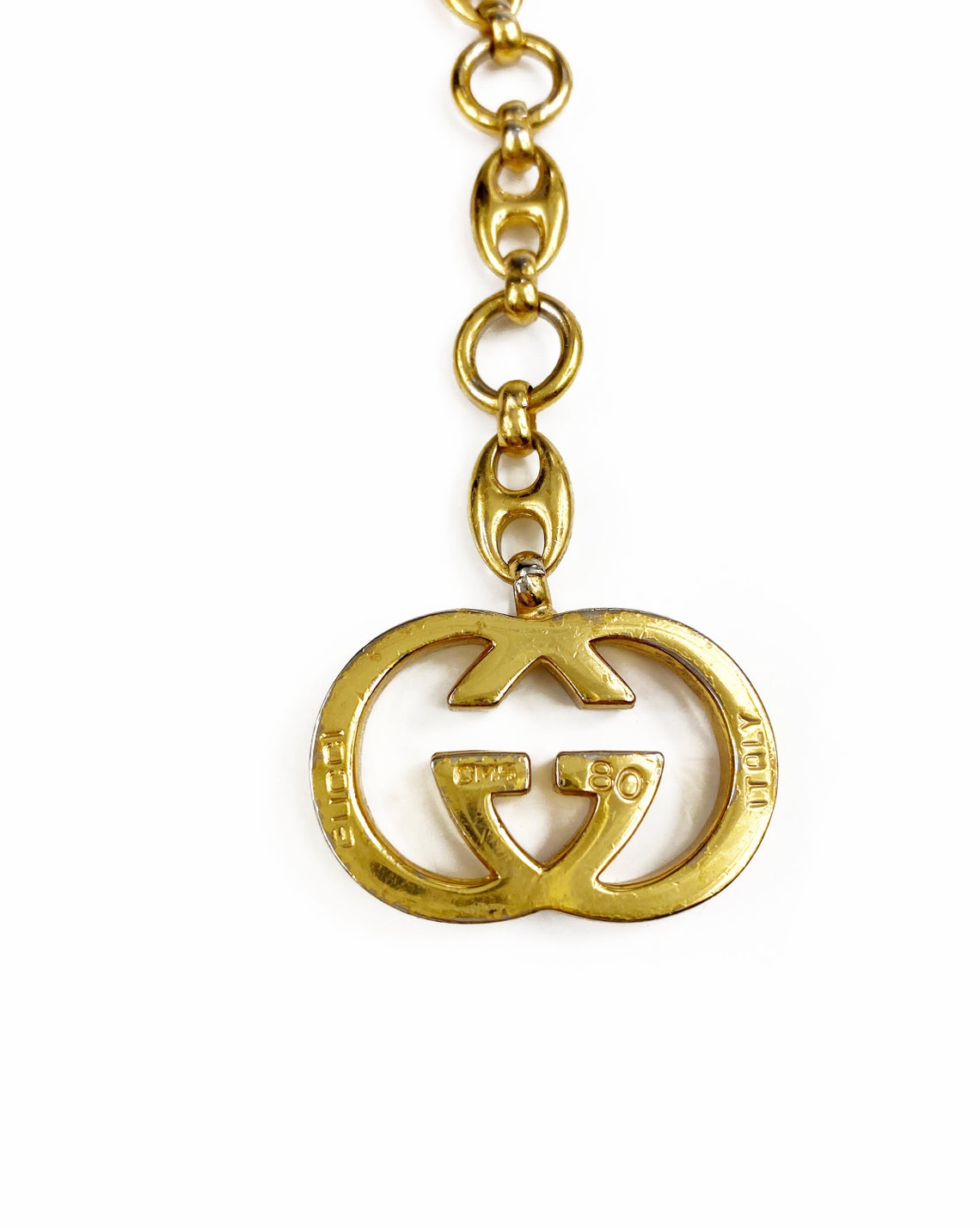 Fruit Vintage Gucci 1980s logo chain belt in classic gold. Features a lobster clip closure and significant logo drop Gucci GG charm. Looks incredible when worn as a necklace.