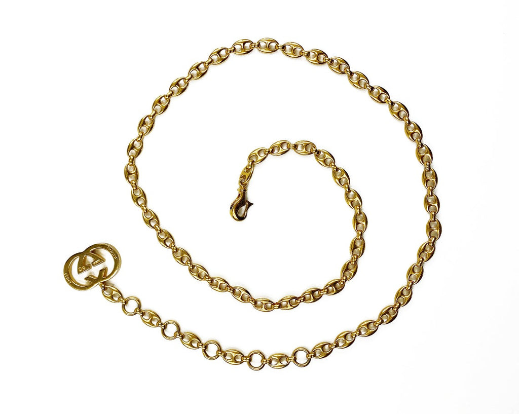 Fruit Vintage Gucci 1980s logo chain belt in classic gold. Features a lobster clip closure and significant logo drop Gucci GG charm. Looks incredible when worn as a necklace.