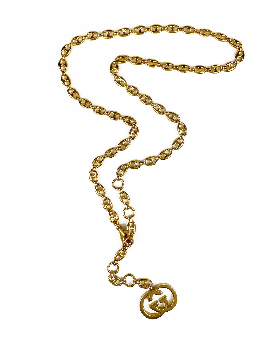 Fruit Vintage Gucci 1980s logo chain belt in classic gold. Features a lobster clip closure and significant logo drop Gucci GG charm. Looks incredible when worn as a necklace.