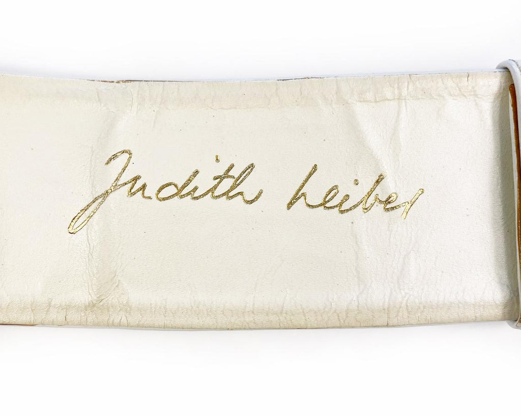 Fruit Vintage iconic Judith Leiber lion head belt with drop chains. This piece is amazing! It features 3 very large gold tone metal lions heads with drop chains on a white leather belt.