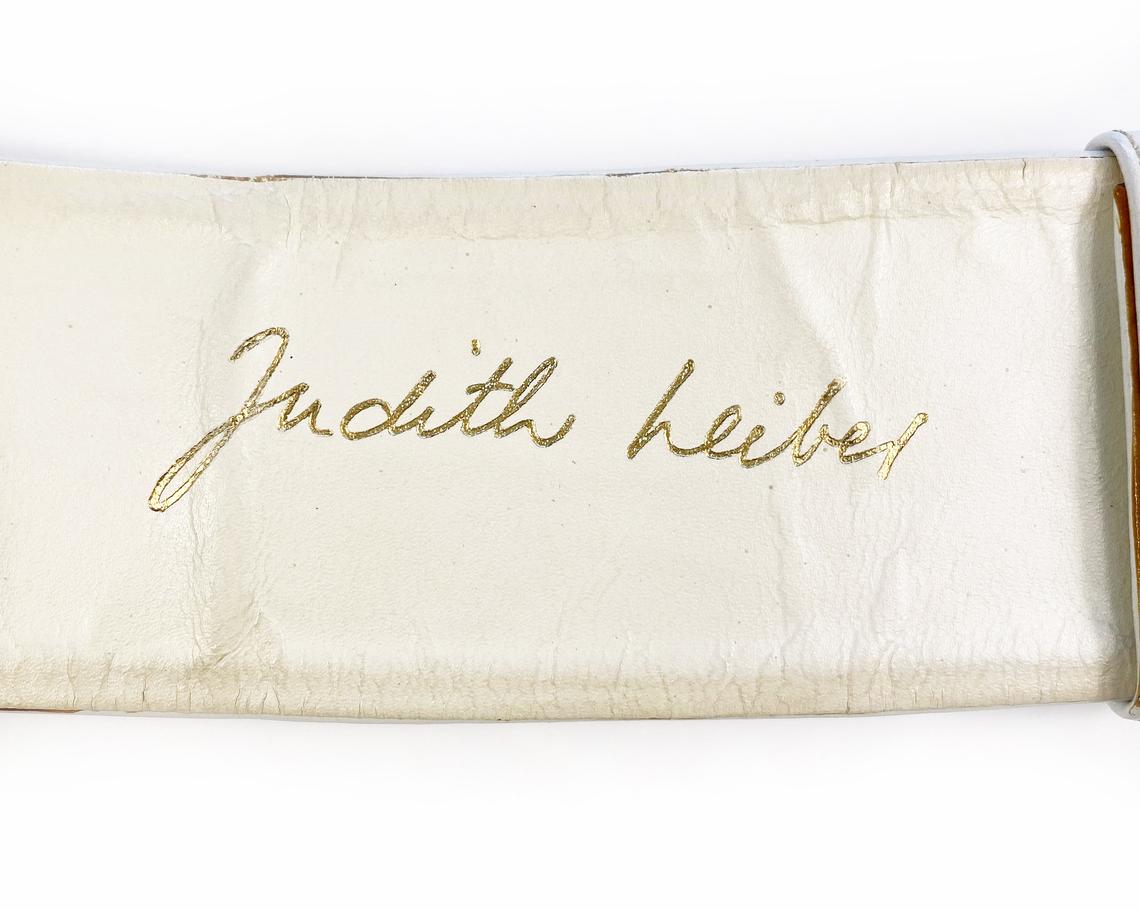 Fruit Vintage iconic Judith Leiber lion head belt with drop chains. This piece is amazing! It features 3 very large gold tone metal lions heads with drop chains on a white leather belt.