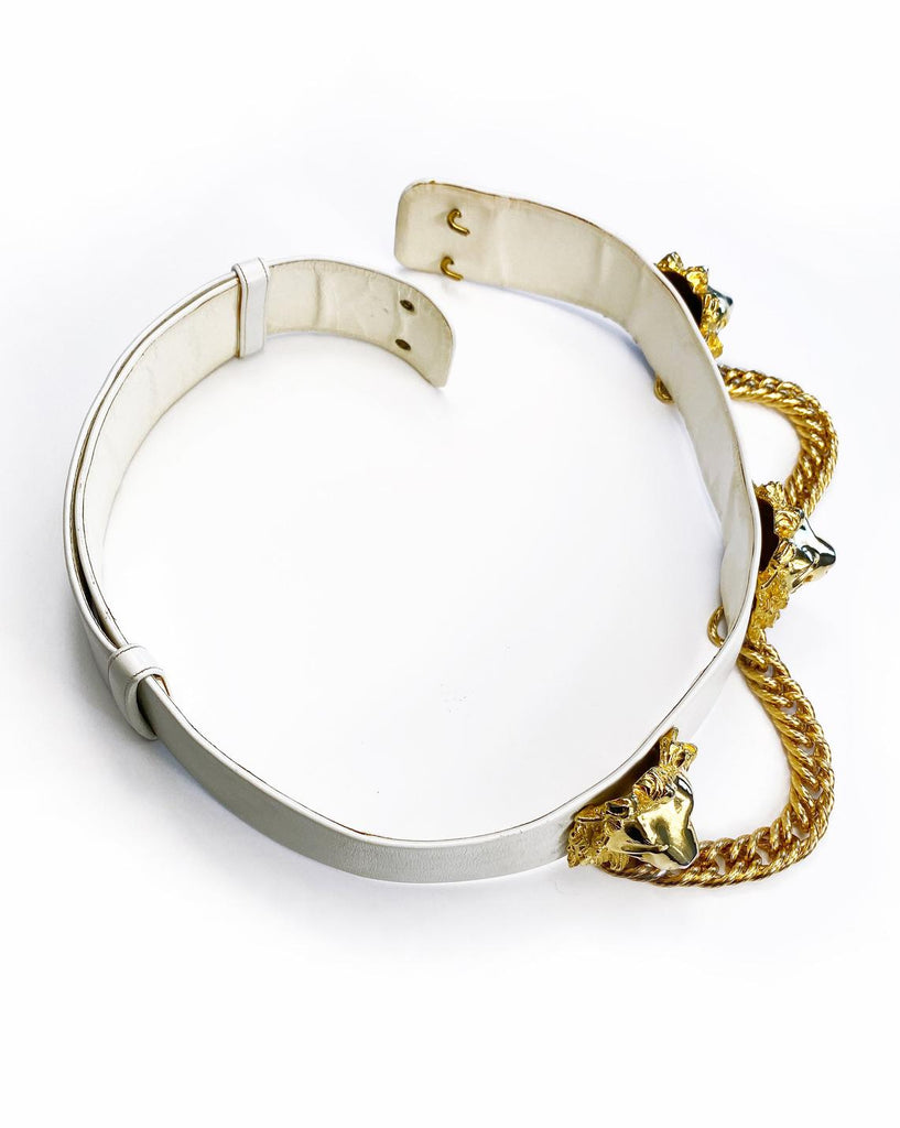 Fruit Vintage iconic Judith Leiber lion head belt with drop chains. This piece is amazing! It features 3 very large gold tone metal lions heads with drop chains on a white leather belt.