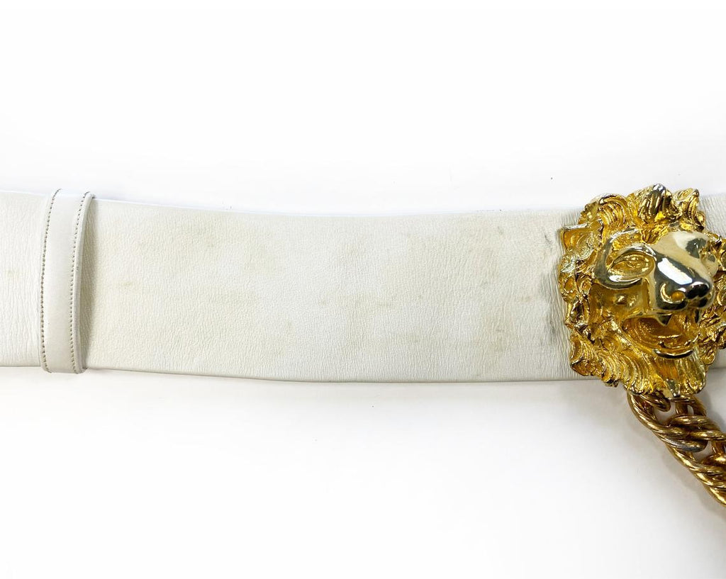 Fruit Vintage iconic Judith Leiber lion head belt with drop chains. This piece is amazing! It features 3 very large gold tone metal lions heads with drop chains on a white leather belt.