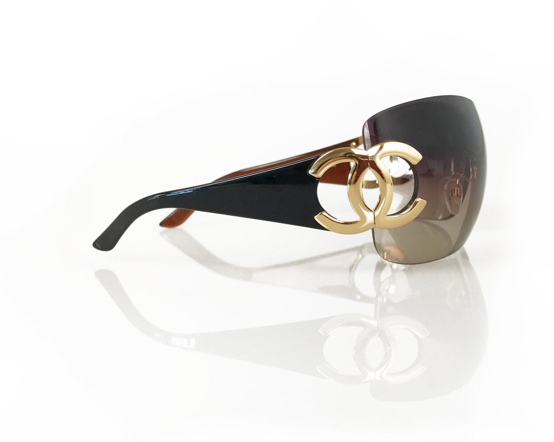 Fruit Vintage Chanel large Y2K logo sunglasses. They feature big Chanel CC logo monograms to each side and a classic early 2000s shield shape.