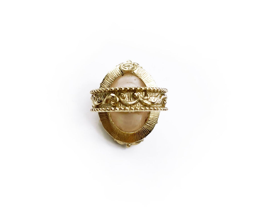 Fruit Vintage Chanel glass set logo ring. Features an ornate filigree style setting with pale pink glass stone with large CC logo inset.