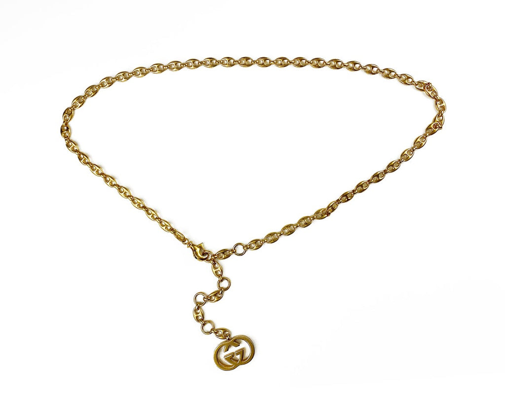 Fruit Vintage Gucci 1980s logo chain belt in classic gold. Features a lobster clip closure and significant logo drop Gucci GG charm. Looks incredible when worn as a necklace.