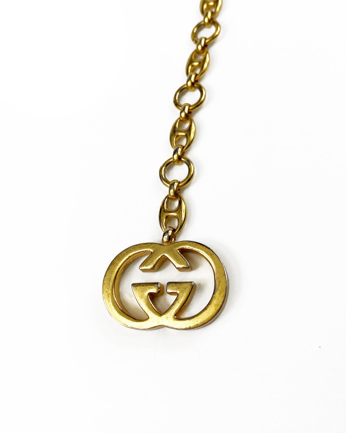 Fruit Vintage Gucci 1980s logo chain belt in classic gold. Features a lobster clip closure and significant logo drop Gucci GG charm. Looks incredible when worn as a necklace.