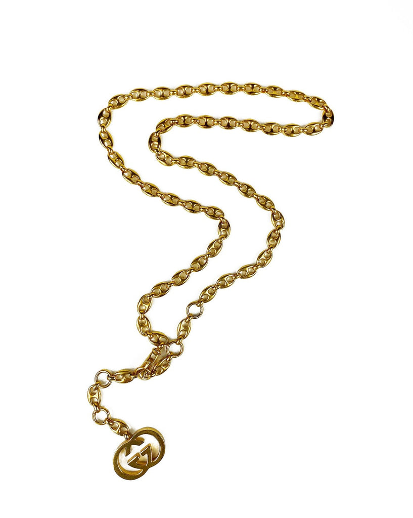 Fruit Vintage Gucci 1980s logo chain belt in classic gold. Features a lobster clip closure and significant logo drop Gucci GG charm. Looks incredible when worn as a necklace.