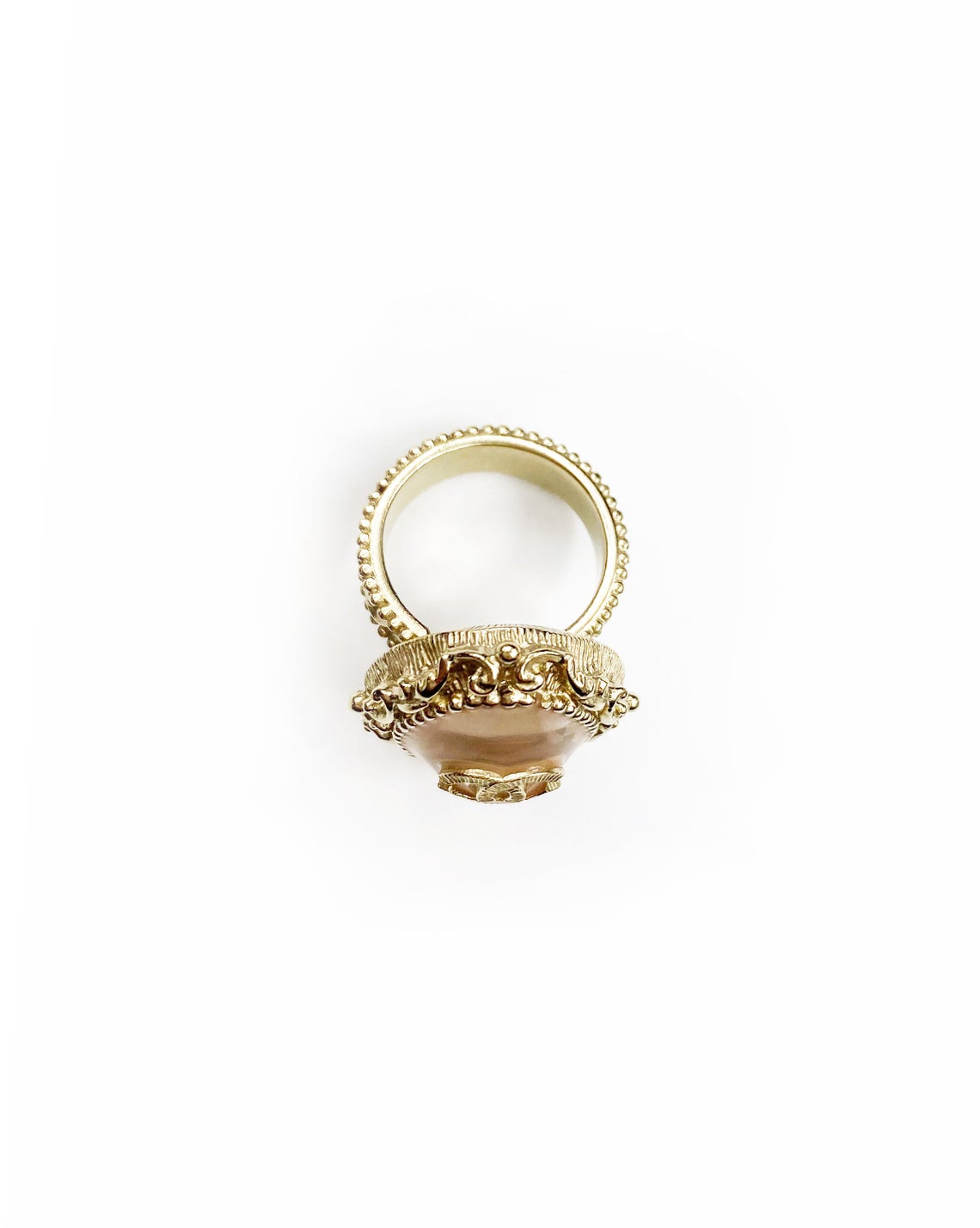Fruit Vintage Chanel glass set logo ring. Features an ornate filigree style setting with pale pink glass stone with large CC logo inset.