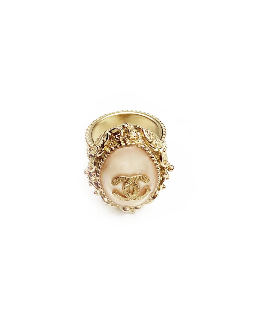 Fruit Vintage Chanel glass set logo ring. Features an ornate filigree style setting with pale pink glass stone with large CC logo inset.