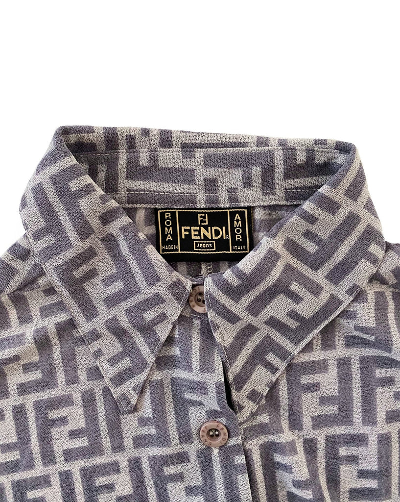 FRUIT Vintage Fendi Zucca print button up shirt dating to the early 90s. This amazing piece is made from a sheer mesh and features a bold Fendi Zucca print in two tone grey.
