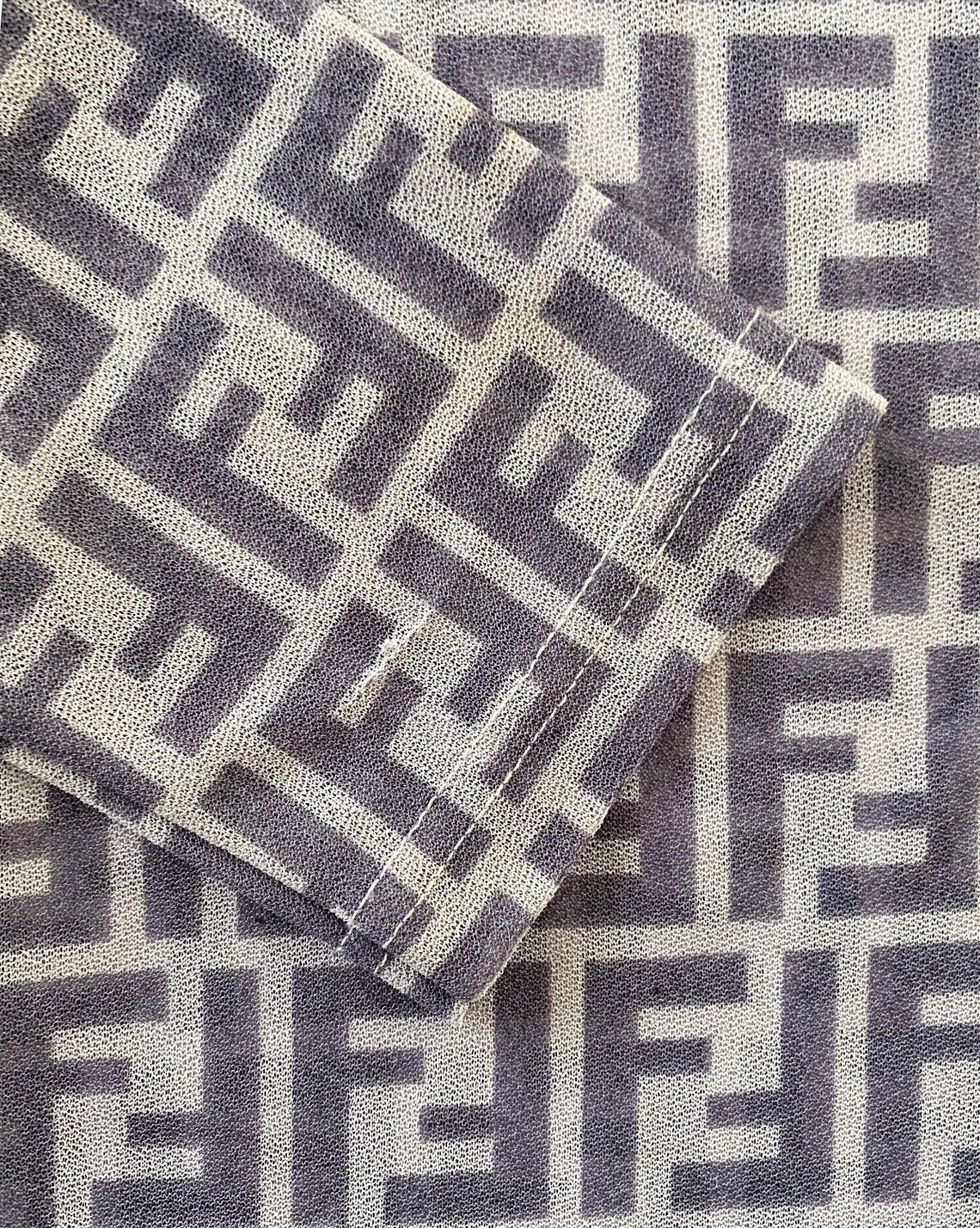FRUIT Vintage Fendi Zucca print button up shirt dating to the early 90s. This amazing piece is made from a sheer mesh and features a bold Fendi Zucca print in two tone grey.