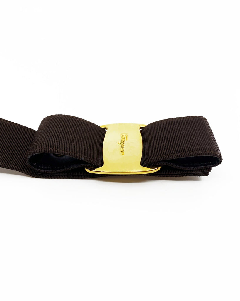 Fruit Vintage Salvatore Ferragamo 1980s bow belt in dark brown gross grain fabric. It features the iconic Ferragamo bow design with a large logo plate at front.