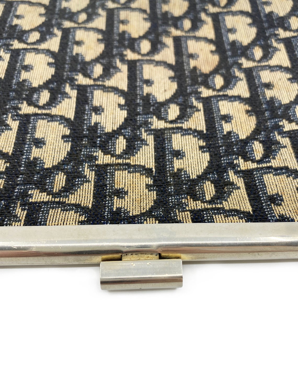 FRUIT vintage 1970s Christian Dior logo clutch bag is made of Navy Dior trotter print canvas and features a gold hardware clip top closure.