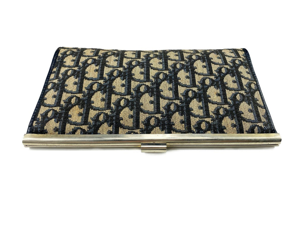 FRUIT vintage 1970s Christian Dior logo clutch bag is made of Navy Dior trotter print canvas and features a gold hardware clip top closure.