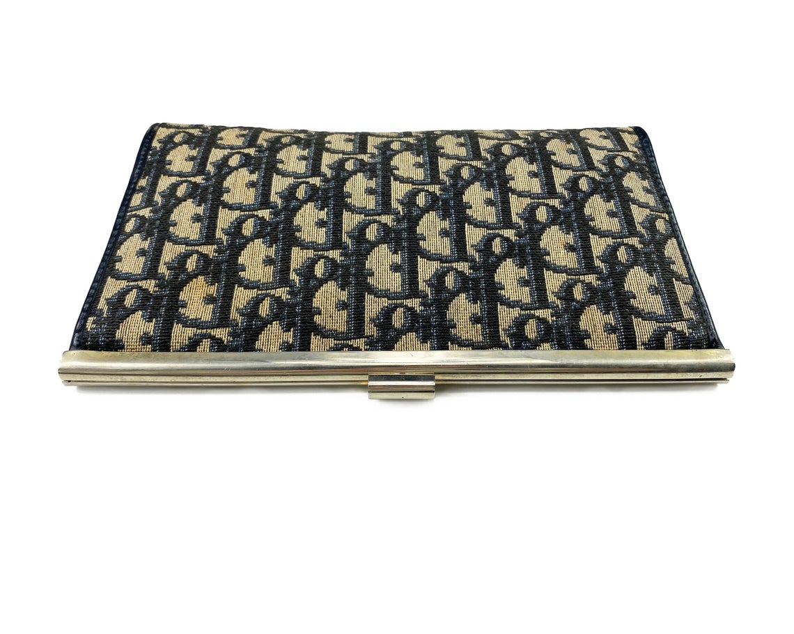 FRUIT vintage 1970s Christian Dior logo clutch bag is made of Navy Dior trotter print canvas and features a gold hardware clip top closure.