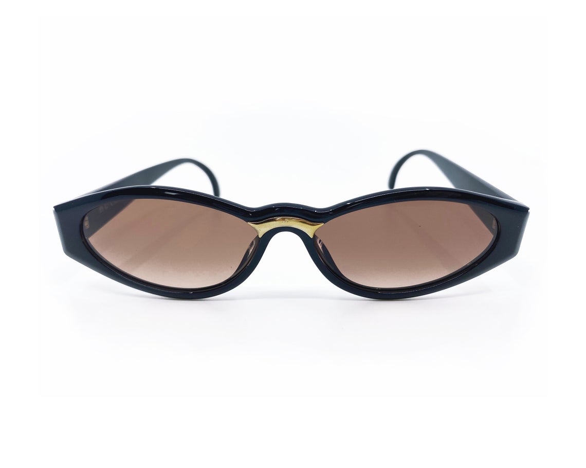 Fruit Vintage Christian Dior sunglasses dating to 1990. These small oval frames feature a gold trim over the nose and CD logo to each arm.