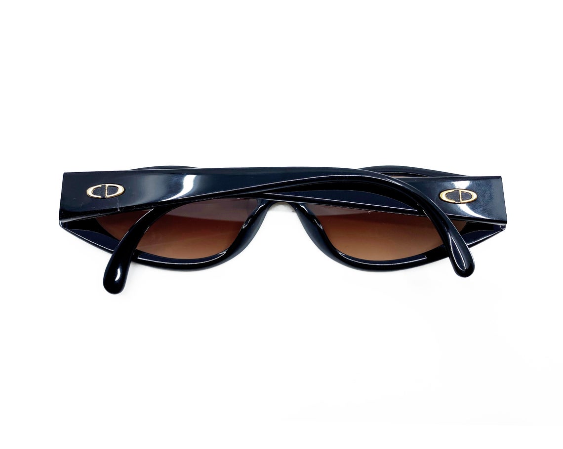 Fruit Vintage Christian Dior sunglasses dating to 1990. These small oval frames feature a gold trim over the nose and CD logo to each arm.