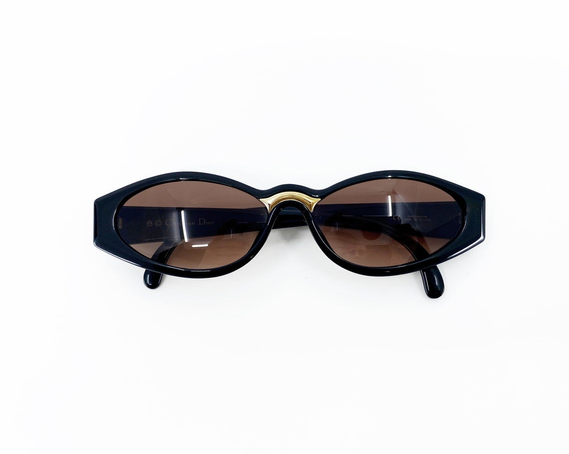 Fruit Vintage Christian Dior sunglasses dating to 1990. These small oval frames feature a gold trim over the nose and CD logo to each arm.