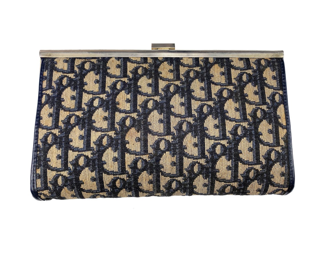 FRUIT vintage 1970s Christian Dior logo clutch bag is made of Navy Dior trotter print canvas and features a gold hardware clip top closure.