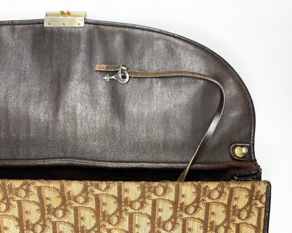 FRUIT Vintage 1970s Christian Dior brown canvas trotter monogram clutch bag. Features a pochette/soft brief case style shape with front clip closure with key and full leather lining. Perfect as a laptop case or document holder!