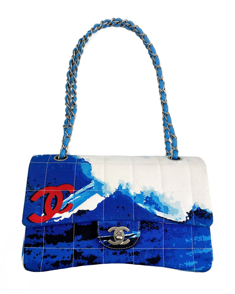 Fruit Vintage Chanel quilted surf print logo canvas flap bag. Features a graphic blue and white surf/wave print on canvas, a square quilted stitching design, classic Chanel flap and zipper closure with Chanel logo pull.
