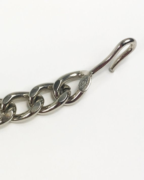 Fruit Vintage Chanel logo monogram letter chain belt in classic silver. Features a hook closure and logo drop Chanel CC charm.