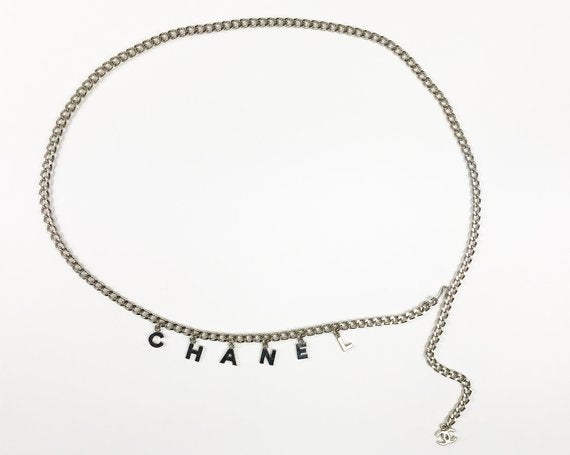 Fruit Vintage Chanel logo monogram letter chain belt in classic silver. Features a hook closure and logo drop Chanel CC charm.
