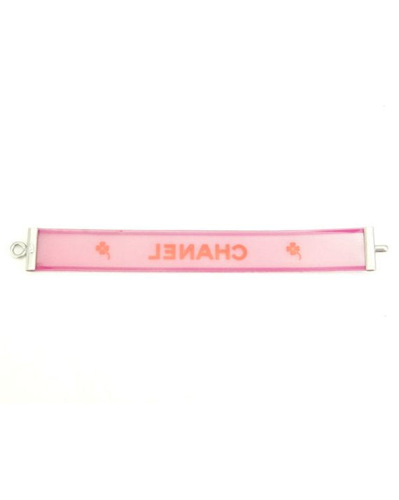 Fruit Vintage Chanel pink and orange rubber logo cuff bracelet with large CHANEL text logo to the centre and two clover symbols either side.