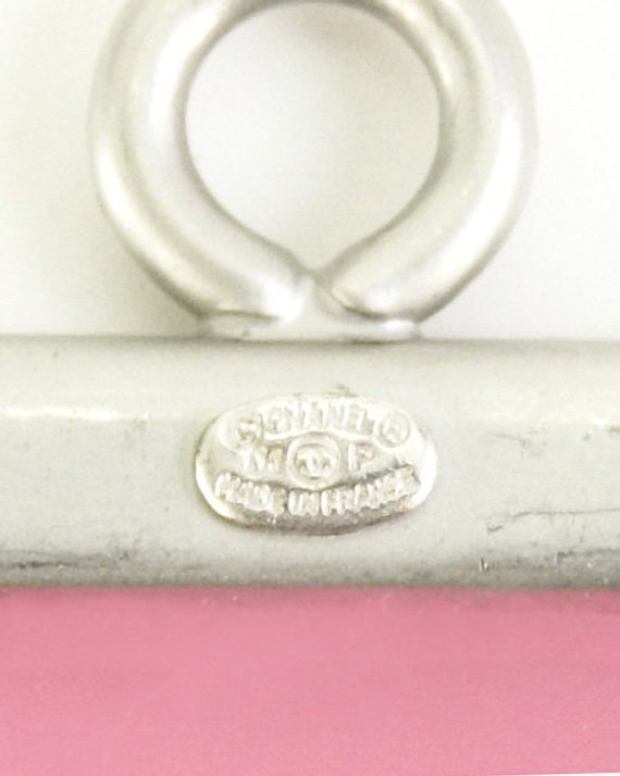 Fruit Vintage Chanel pink and orange rubber logo cuff bracelet with large CHANEL text logo to the centre and two clover symbols either side.