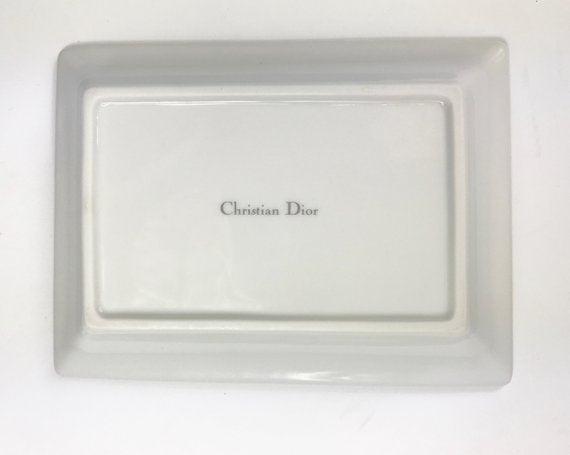 FRUIT Vintage Christian Dior very rare porcelain change tray featuring the 1980s logo in the center surrounded by vibrant green and blue tones and floral motifs.