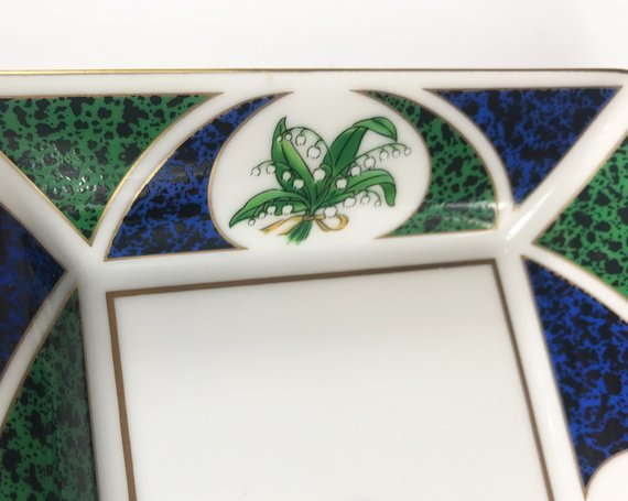 FRUIT Vintage Christian Dior very rare porcelain change tray featuring the 1980s logo in the center surrounded by vibrant green and blue tones and floral motifs.
