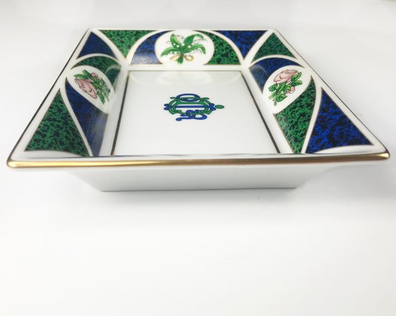 FRUIT Vintage Christian Dior very rare porcelain change tray featuring the 1980s logo in the center surrounded by vibrant green and blue tones and floral motifs.