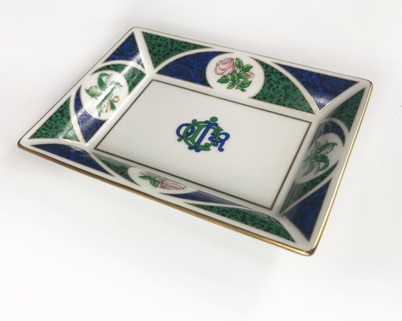 FRUIT Vintage Christian Dior very rare porcelain change tray featuring the 1980s logo in the center surrounded by vibrant green and blue tones and floral motifs.