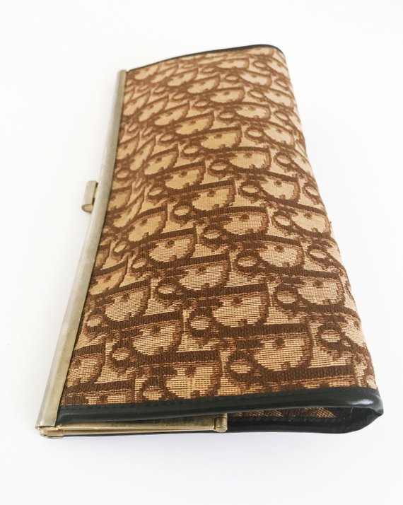 FRUIT vintage 1970s Christian Dior clutch bag is made of Brown oblique monogram logo trotter print canvas and features a gold hardware clip top closure.