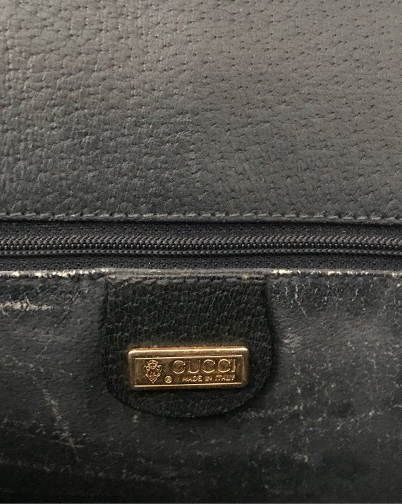 Fruit Vintage Gucci 1980s Logo embellished cross body satchel bag in a navy coated version of the classic Gucci monogram canvas.
