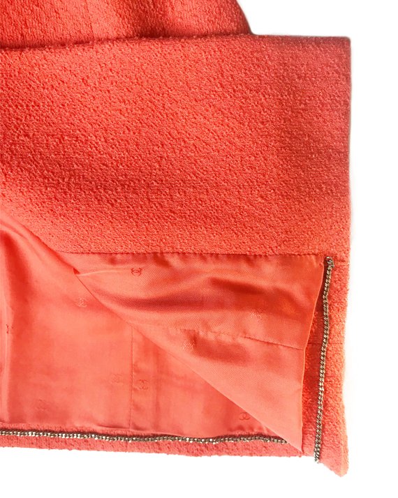 Fruit Vintage Chanel boucle jacket in pale neon peach tone. This jacket is from the famous Spring/Summer 1996 RTW collection by Karl Lagerfeld. It features a longer-line length, classic Chanel logo buttons, internal chain hem and two front pockets.