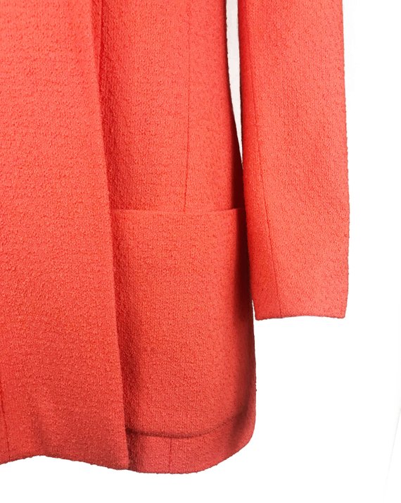 Fruit Vintage Chanel boucle jacket in pale neon peach tone. This jacket is from the famous Spring/Summer 1996 RTW collection by Karl Lagerfeld. It features a longer-line length, classic Chanel logo buttons, internal chain hem and two front pockets.